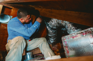 tech working on ductwork