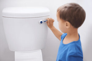 child tries to flush clogged toilet