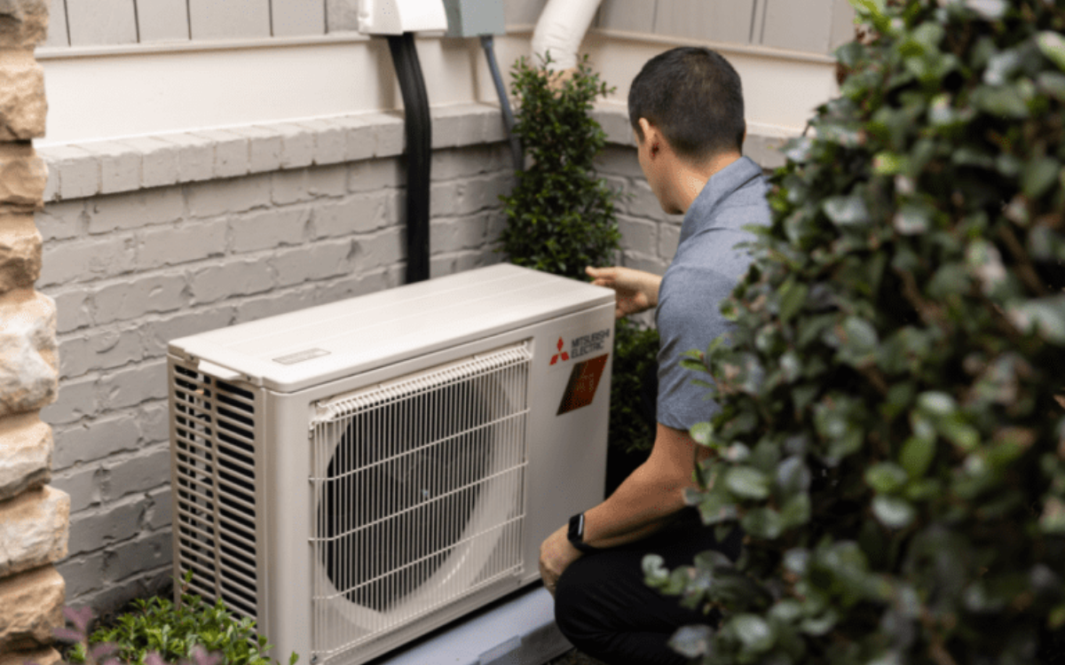 technician fixing HVAC unit
