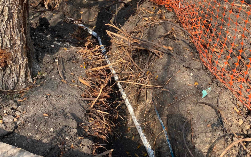 exposed sewer line pipe in the process of being repaired