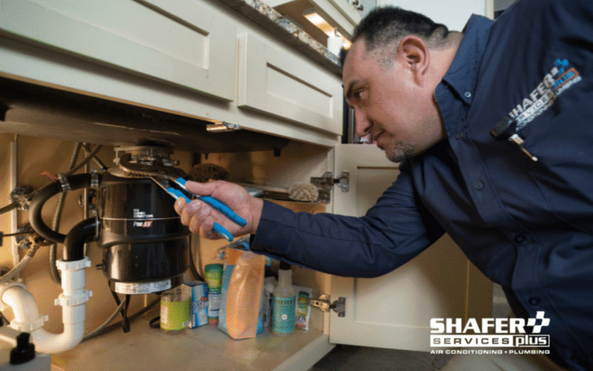 technician fixing plumbing