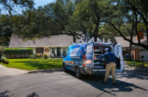 technician grabbing stuff from their van 