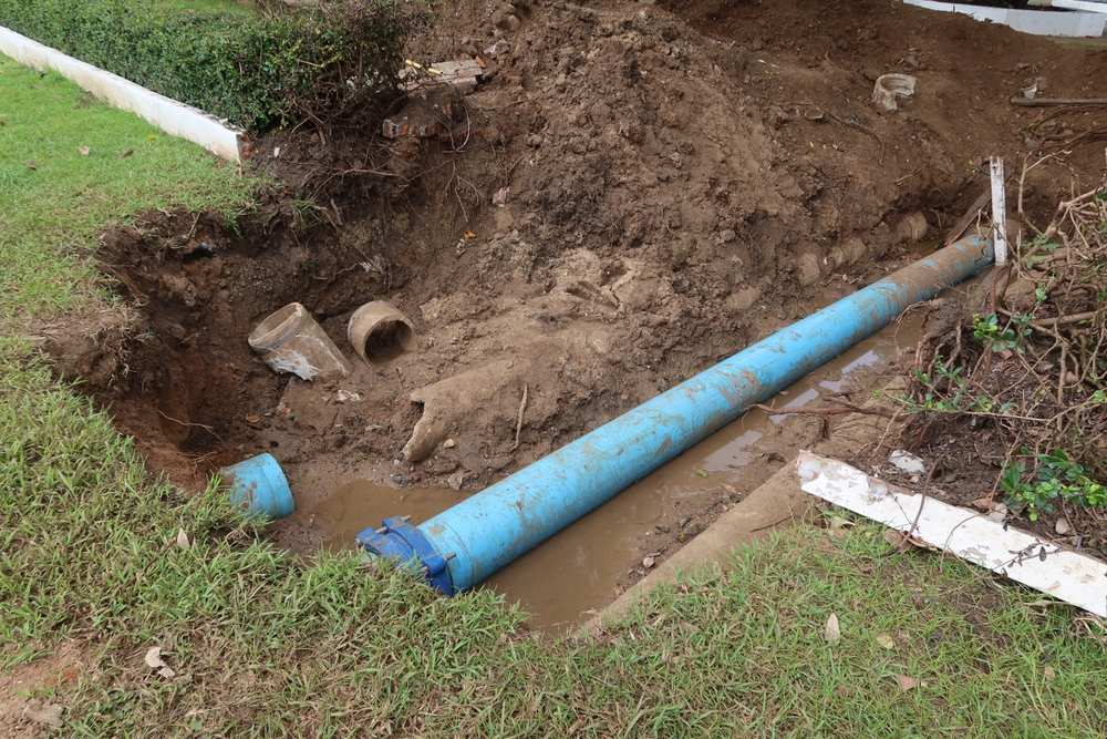 An excavated section of a lawn to access a sewer line.