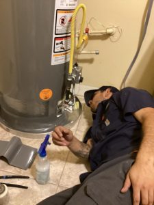 plumber working on water heater